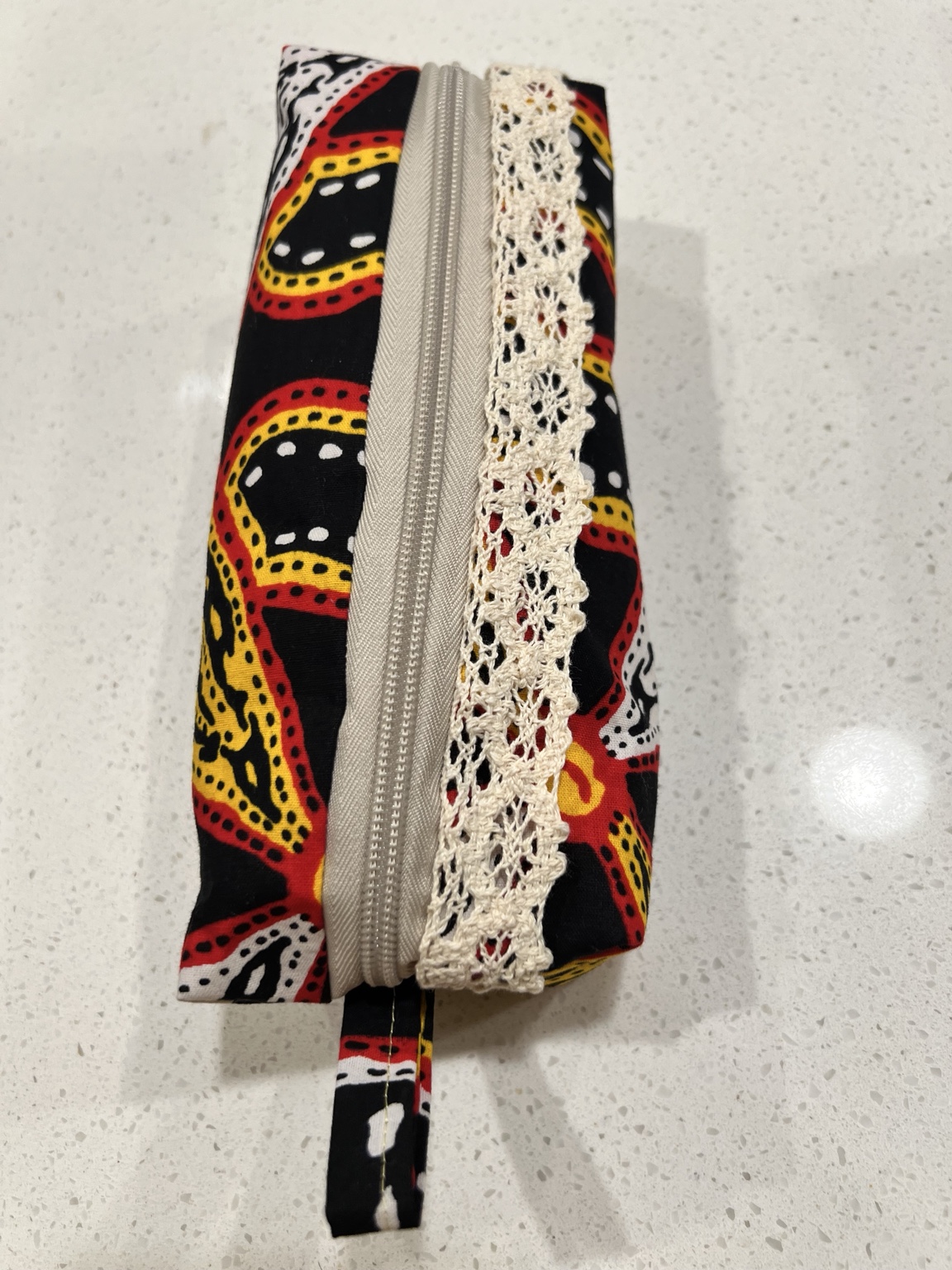 Cameroon fabric pouch with cream zipper and lace