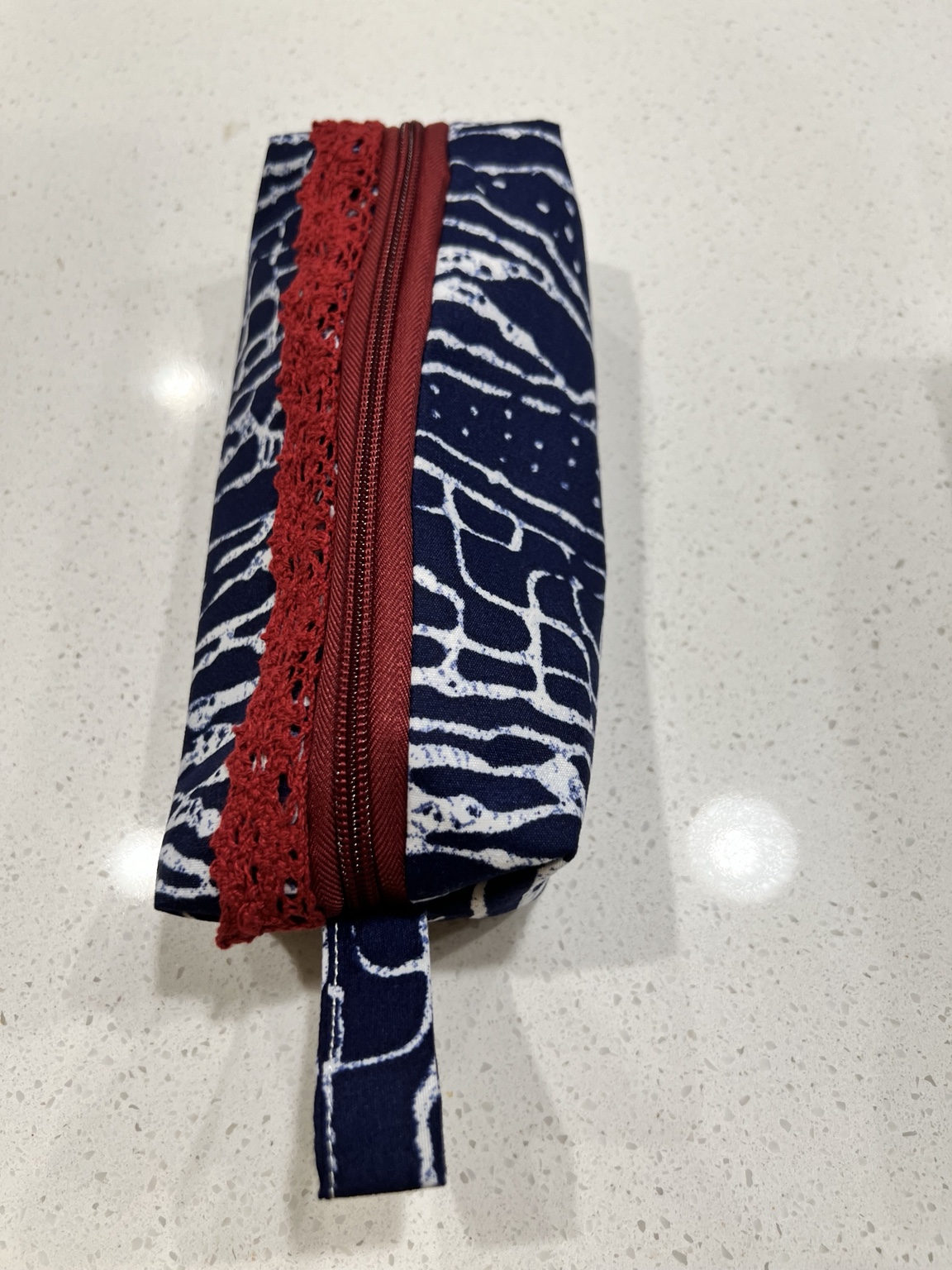 Navy and white Cameroon fabric pouch with red zipper